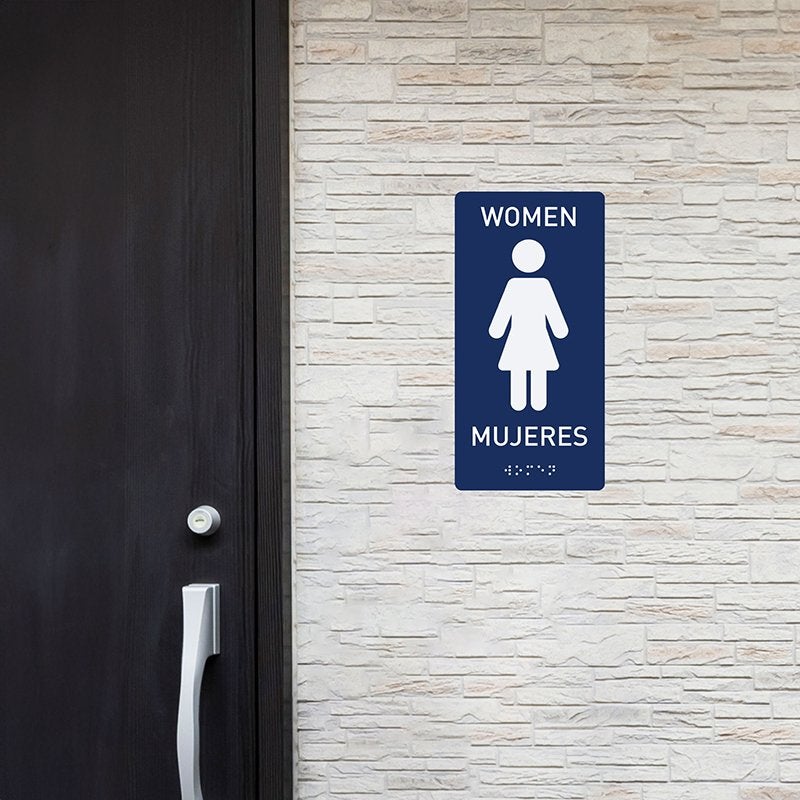 A women's restroom sign with the Spanish translation