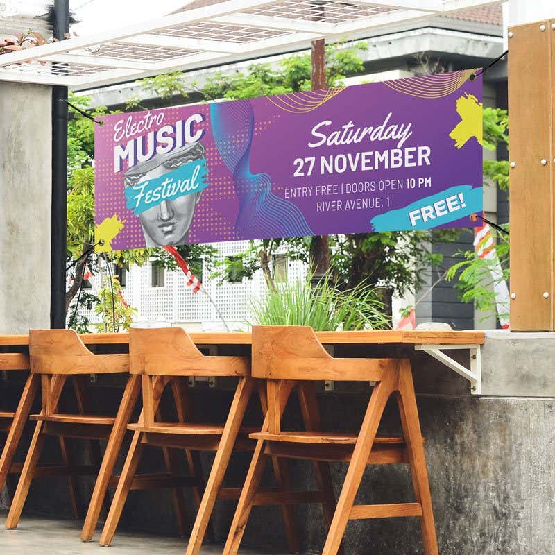 Purple outdoor vinyl banner with bold event typography and graphic design elements, displayed at an open-air venue