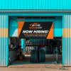 Black and orange outdoor vinyl banner with bold business branding and text, hanging in an auto shop garage doorway