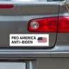 Pro America Anti-Biden bumper sticker below a gray car's tail light