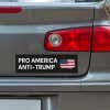 Pro America Anti Trump bumper sticker below a gray car's tail light