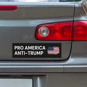 Pro America Anti Trump bumper sticker below a gray car's tail light