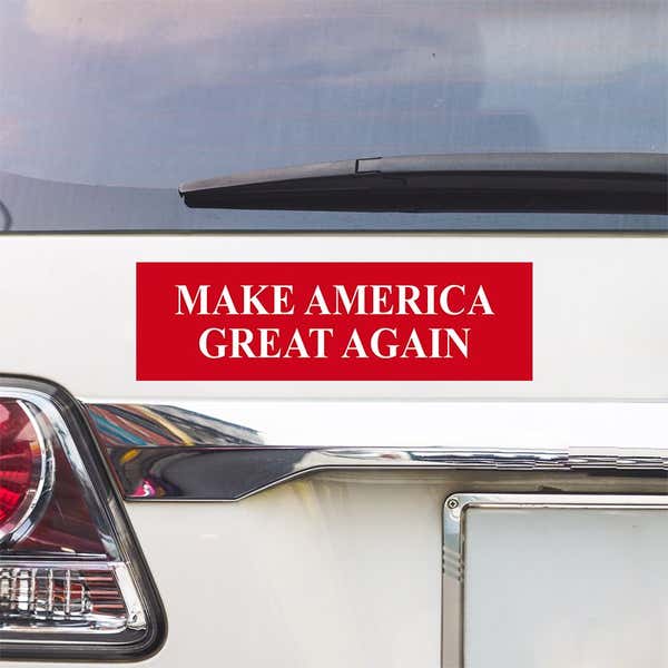 Make American Great Again Bumper Sticker above a white car's tail light