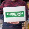 Aliens - Humans Aren't Real Bumper Sticker on a laptop