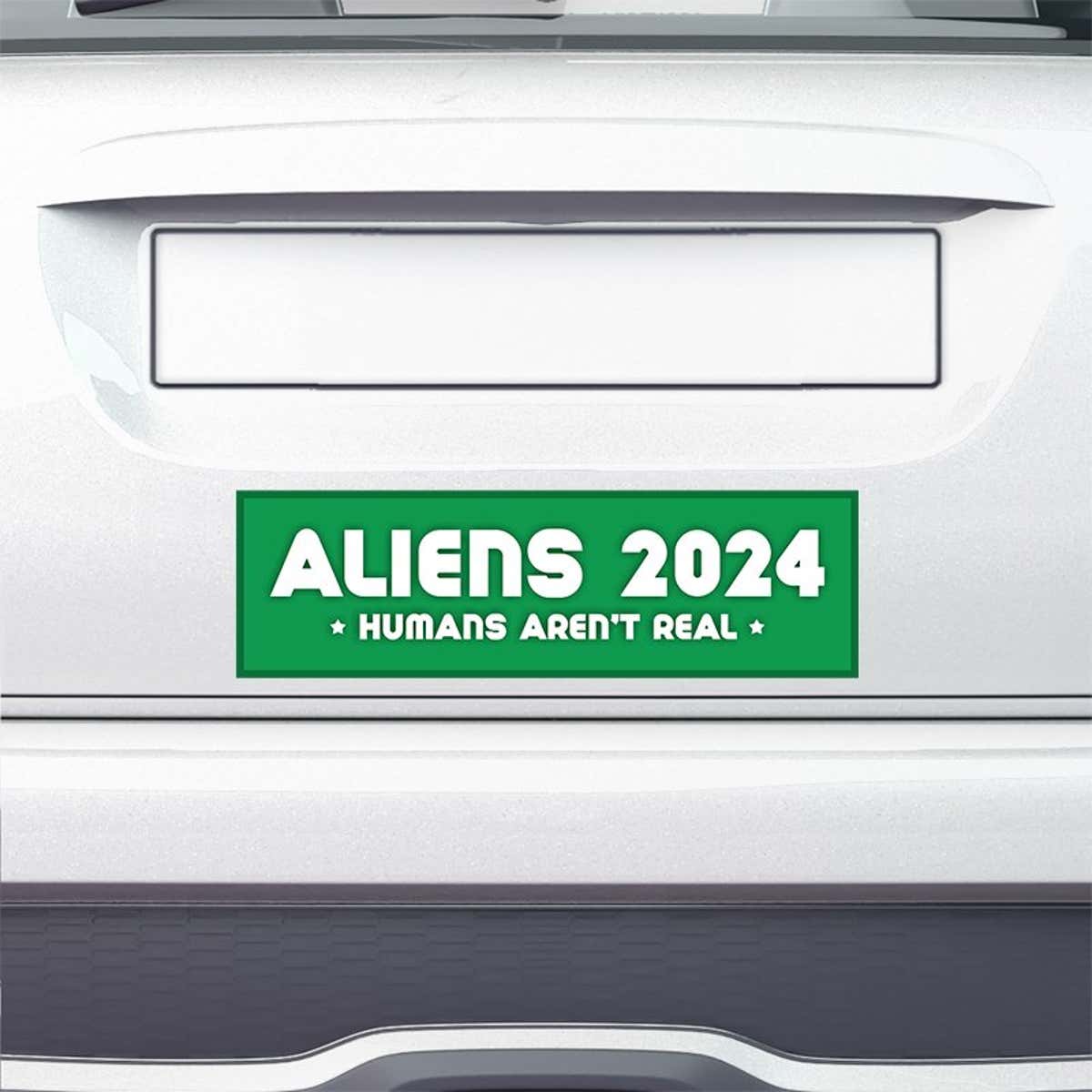 Aliens - Humans Aren't Real Bumper Sticker on the bumper of a white car