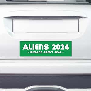 Aliens - Humans Aren't Real Bumper Sticker on the bumper of a white car