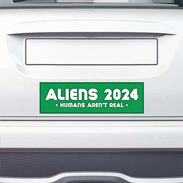 Aliens - Humans Aren't Real Bumper Sticker on the bumper of a white car