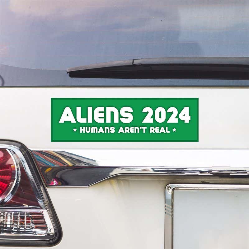 Aliens - Humans Aren't Real Bumper Sticker above a white car's tail light