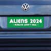Aliens - Humans Aren't Real Bumper Sticker on a gray car