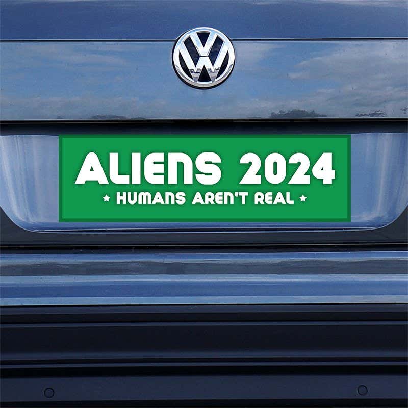 Aliens - Humans Aren't Real Bumper Sticker on a gray car