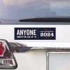Anyone Under 70 bumper sticker above a white car's tail light