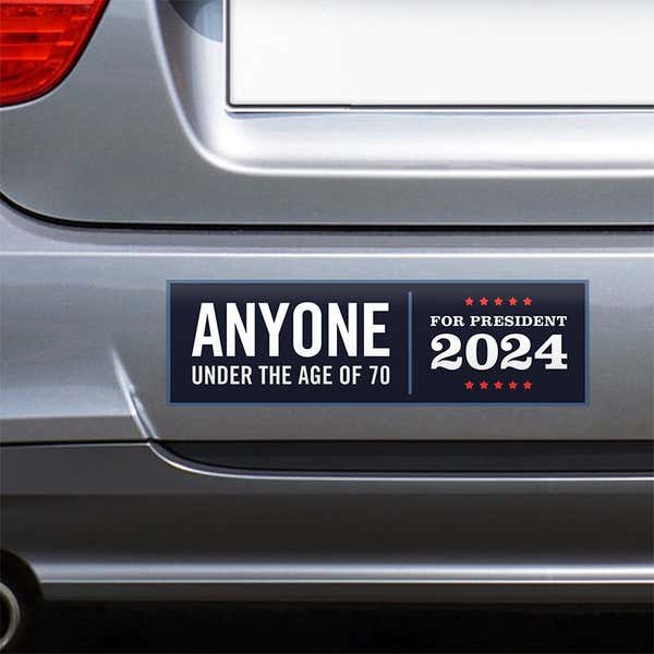 Anyone Under 70 bumper sticker on the bumper of a gray car