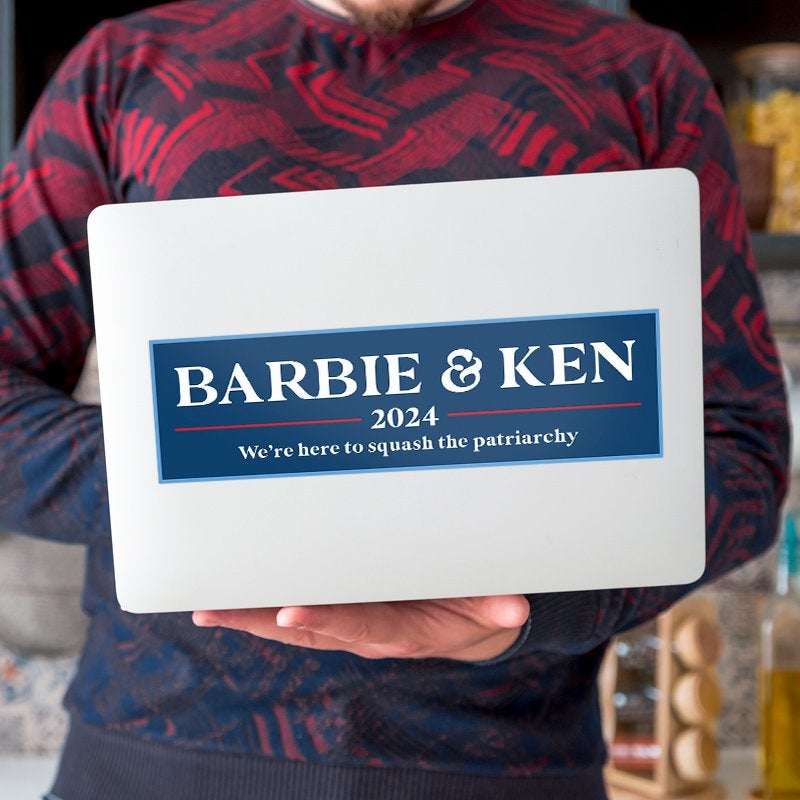 Barbie and Ken bumper sticker on a laptop