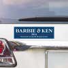 Barbie and Ken bumper sticker above a white car's tail light
