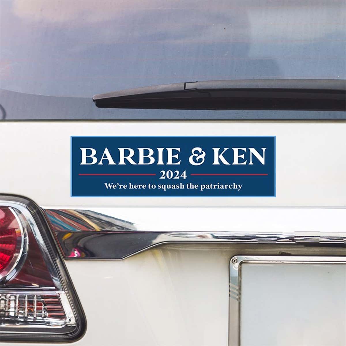 Barbie and Ken bumper sticker above a white car's tail light