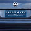 Barbie and Ken bumper sticker on a gray car