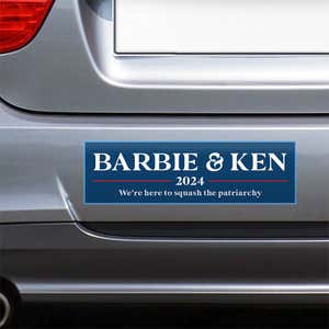Barbie and Ken bumper sticker on the bumper of a gray car