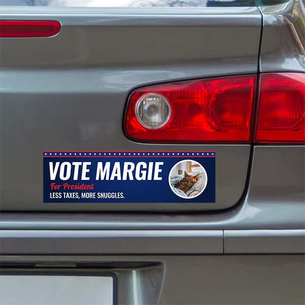 Custom Round Photo Political Bumper Sticker below a gray car's tail light