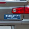 Custom Text Political Bumper Sticker below a gray car's tail light