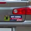 Custom Photo Political Bumper Sticker below a gray car's tail light