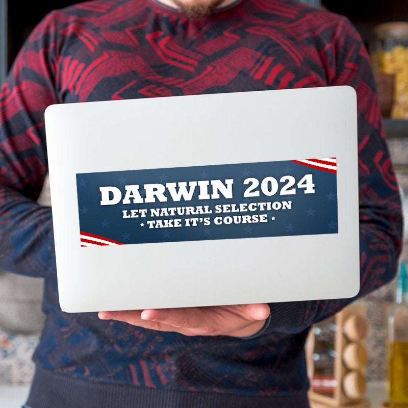 Darwin Political Bumper Sticker on a laptop