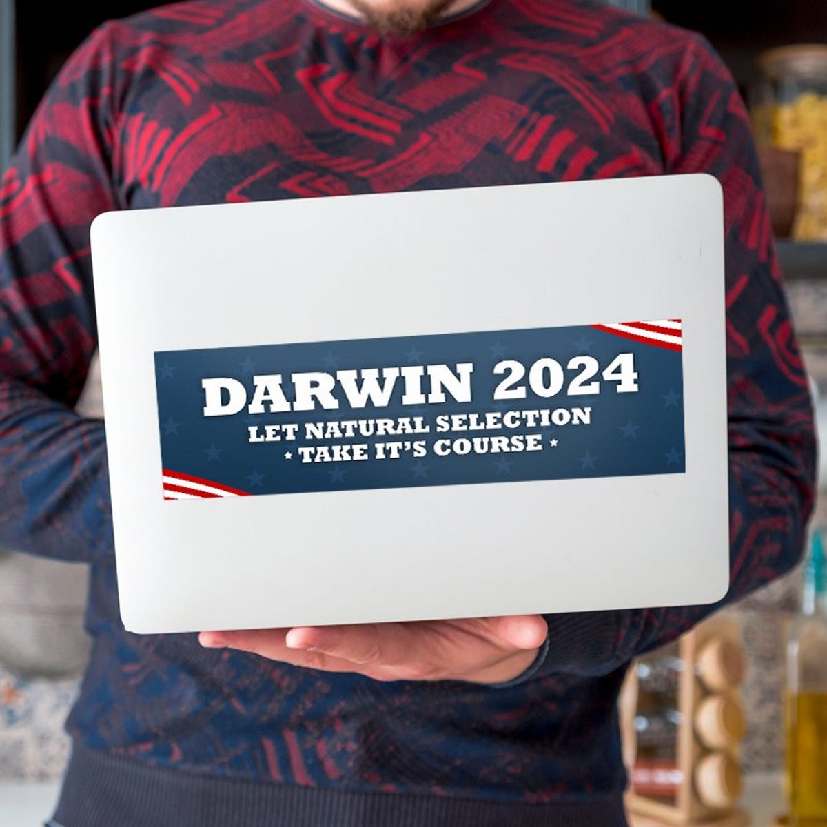Darwin Political Bumper Sticker on a laptop