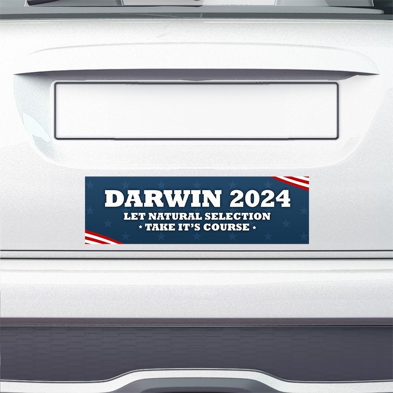 Darwin Political Bumper Sticker on the bumper of a white car
