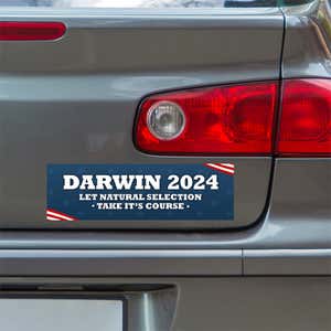 Darwin Political Bumper Sticker below a gray car's tail light