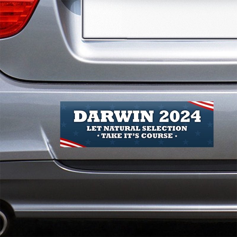 Darwin Political Bumper Sticker on the bumper of a gray car