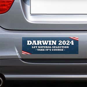 Darwin Political Bumper Sticker on the bumper of a gray car