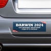 Darwin Political Bumper Sticker on the bumper of a gray car