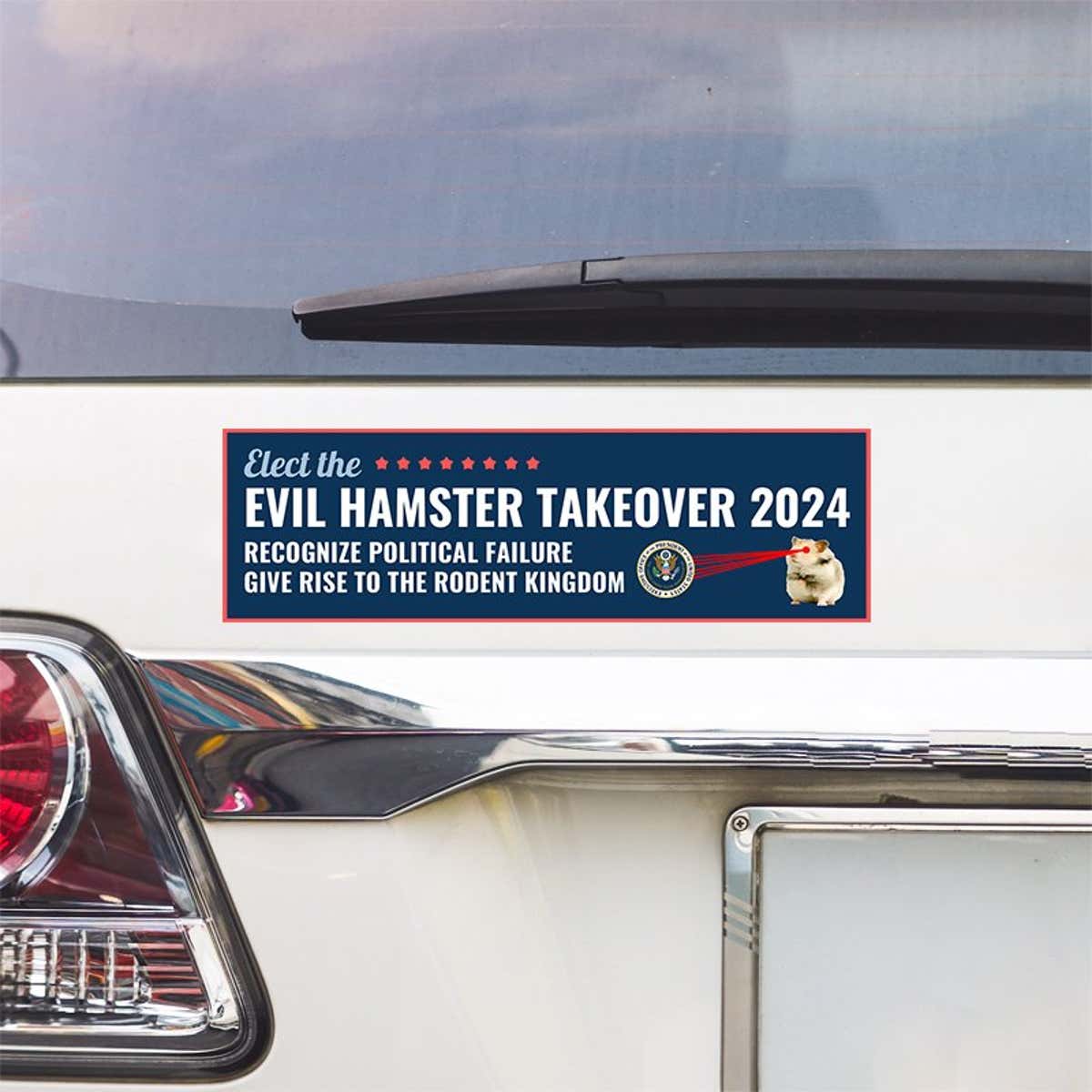 Evil Hamster Political Bumper Sticker above a white car's tail light