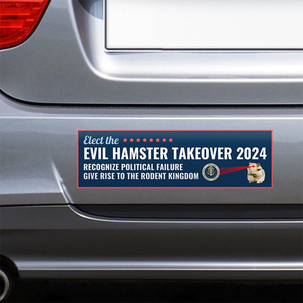 Evil Hamster Political Bumper Sticker on the bumper of a gray car