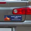 Giant Meteor Bumper Sticker below a gray car's tail light