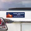 Giant Meteor Bumper Sticker above a white car's tail light