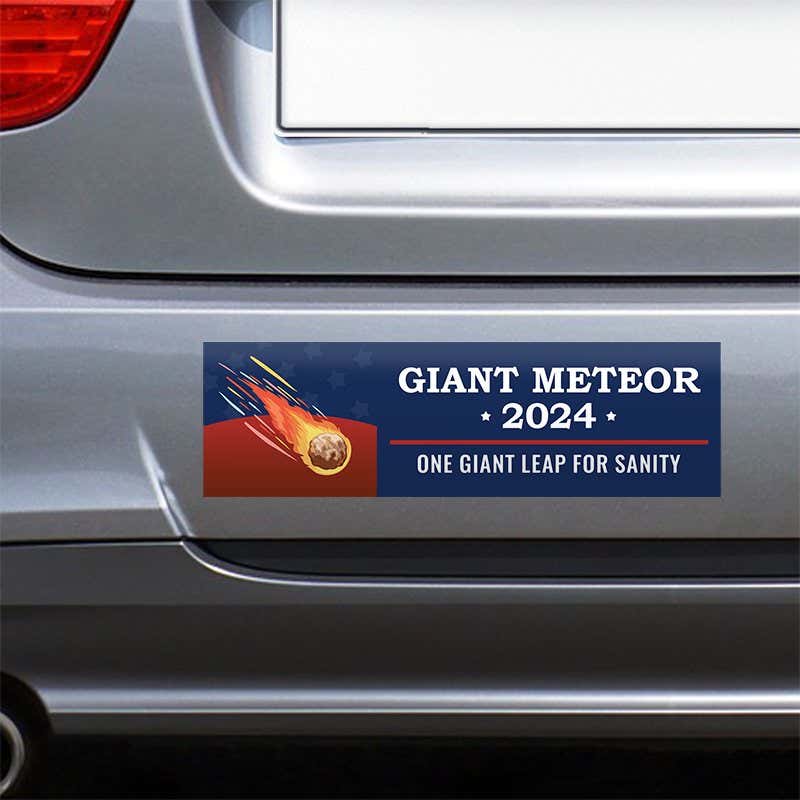 Giant Meteor Bumper Sticker on the bumper of a gray car