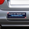 Elect My Trash Can Bumper Sticker on the bumper of a gray car