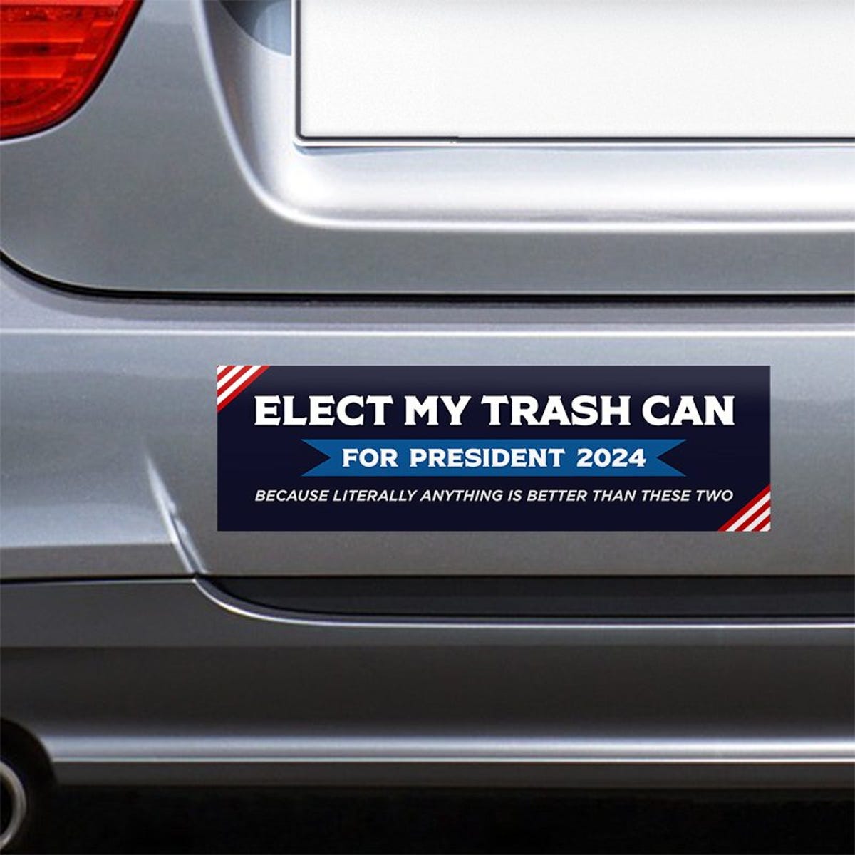 Elect My Trash Can Bumper Sticker on the bumper of a gray car