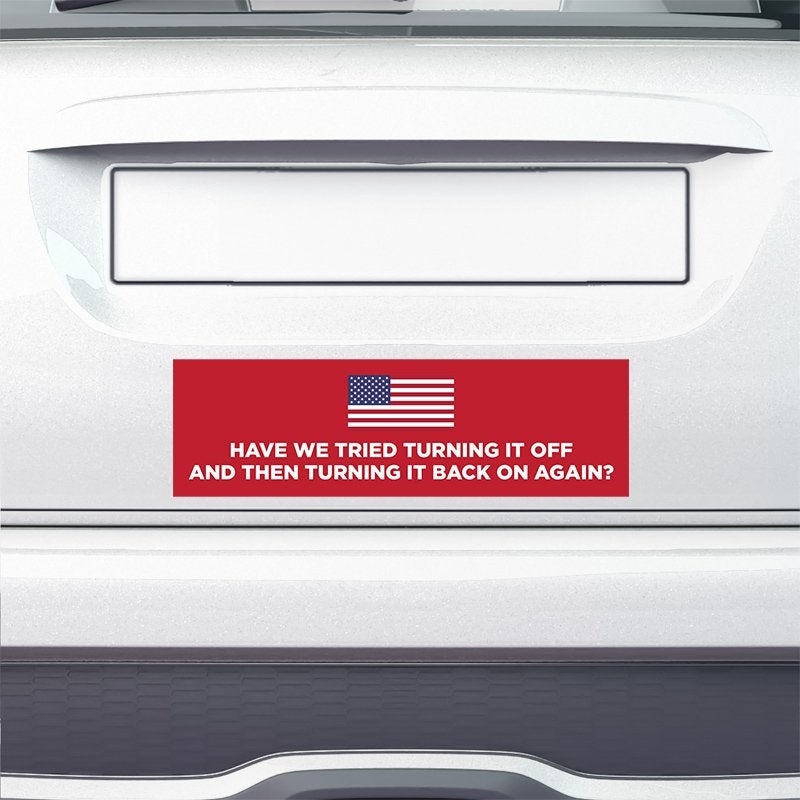 American Flag Funny Political Bumper Sticker on the bumper of a white car