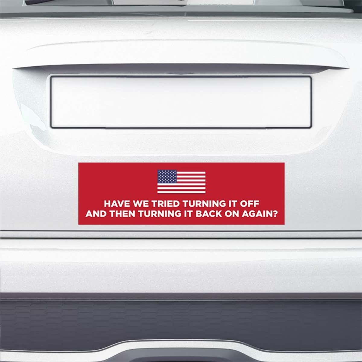 American Flag Funny Political Bumper Sticker on the bumper of a white car