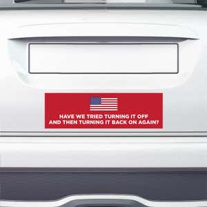 American Flag Funny Political Bumper Sticker on the bumper of a white car