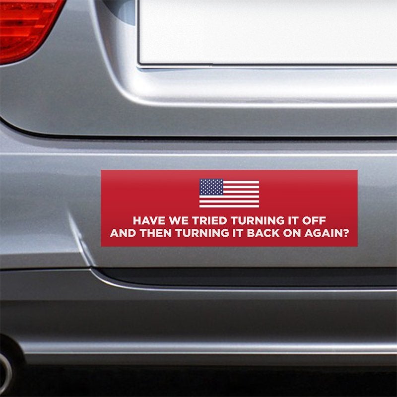 American Flag Funny Political Bumper Sticker on the bumper of a gray car