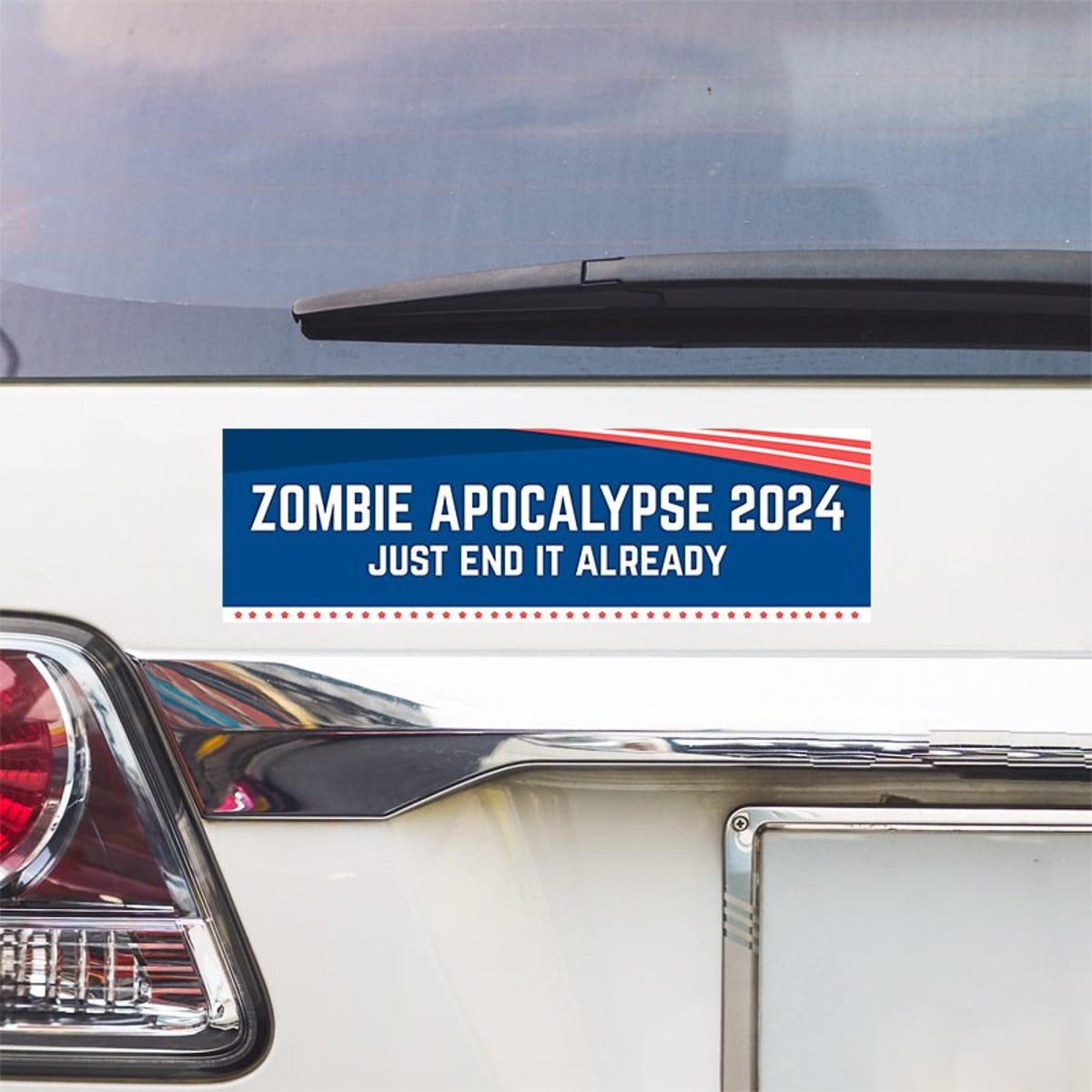 Zombie Apocalypse Political Bumper Sticker above a white car's tail light