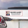 Silver Alert Political Bumper Sticker above a white car's tail light