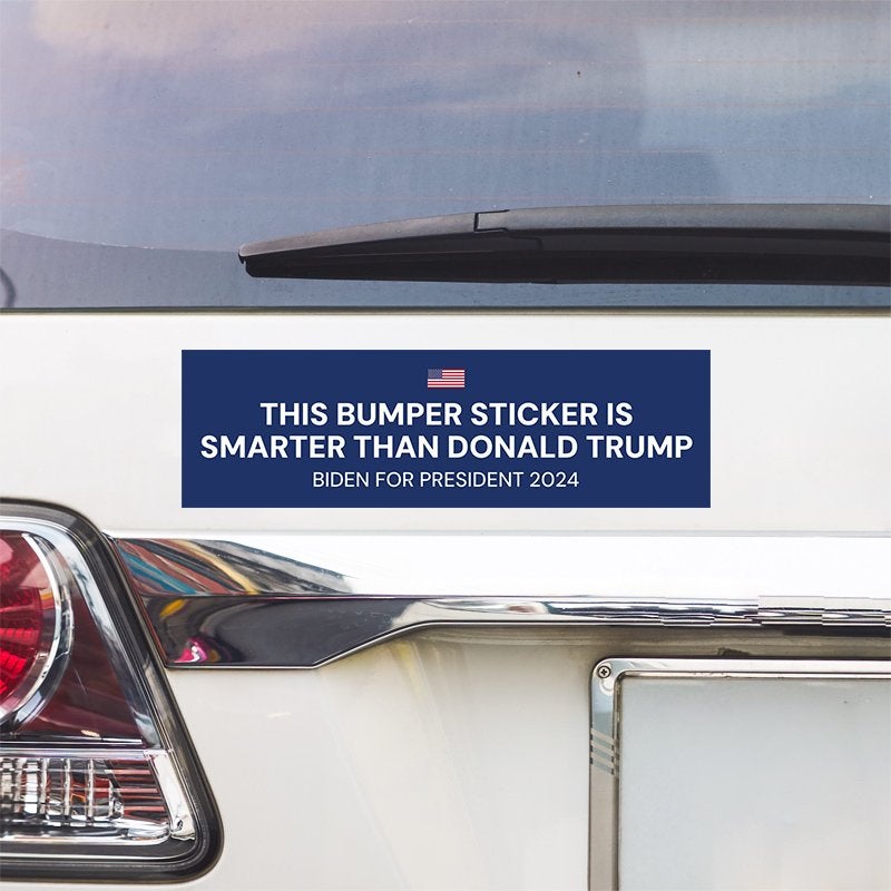 Smarter Than Trump Bumper Sticker above a white car's tail light