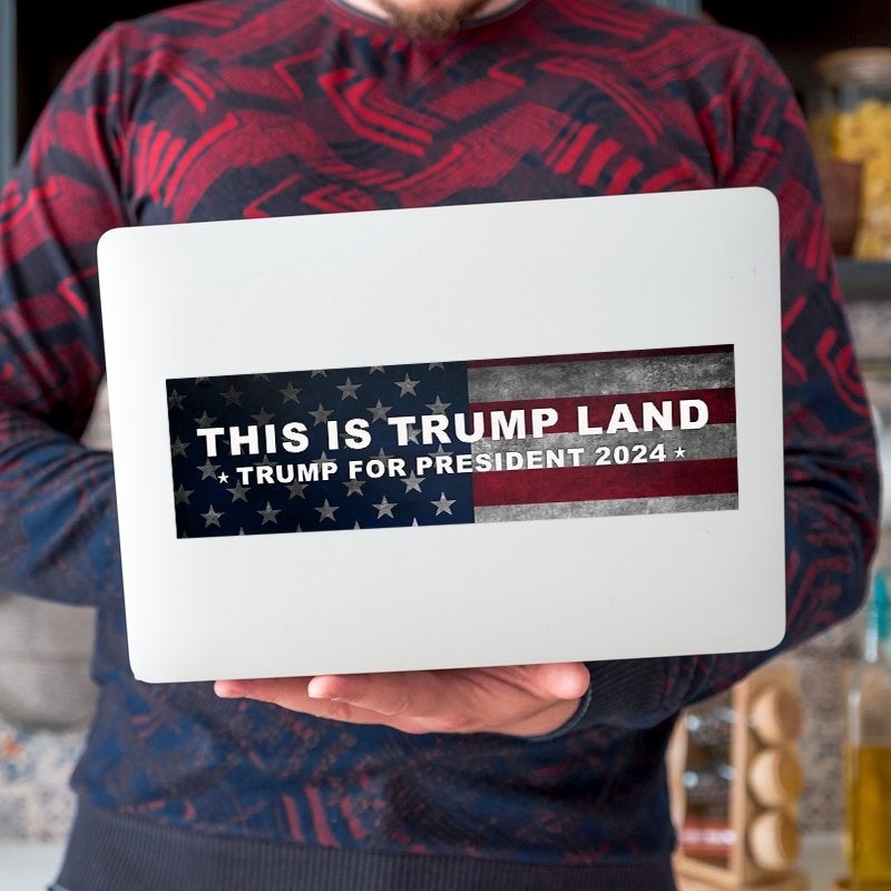 This is Trump Land Bumper Sticker on a laptop