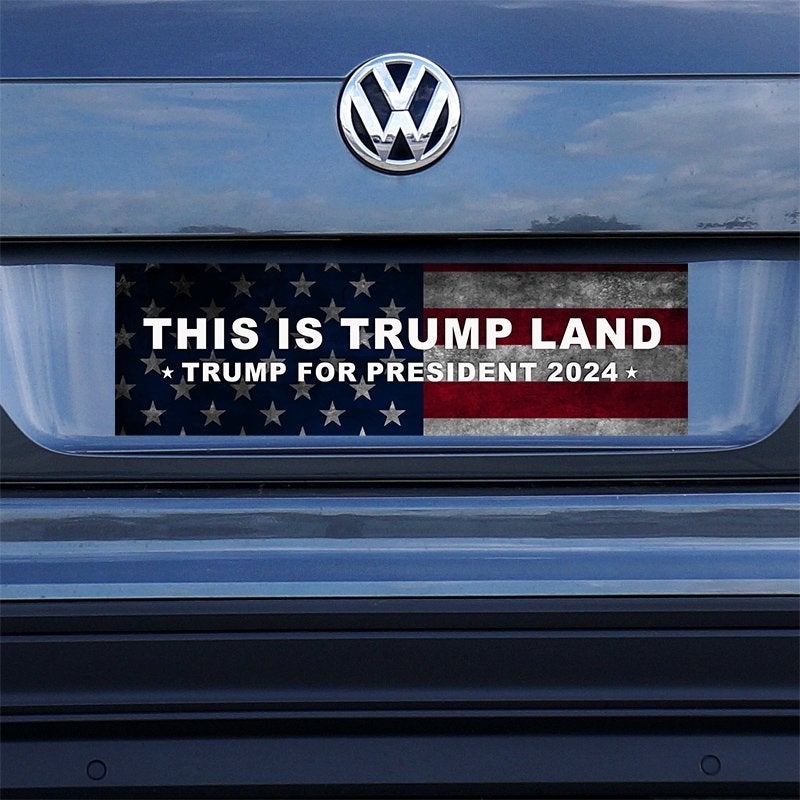 This is Trump Land Bumper Sticker on a gray car