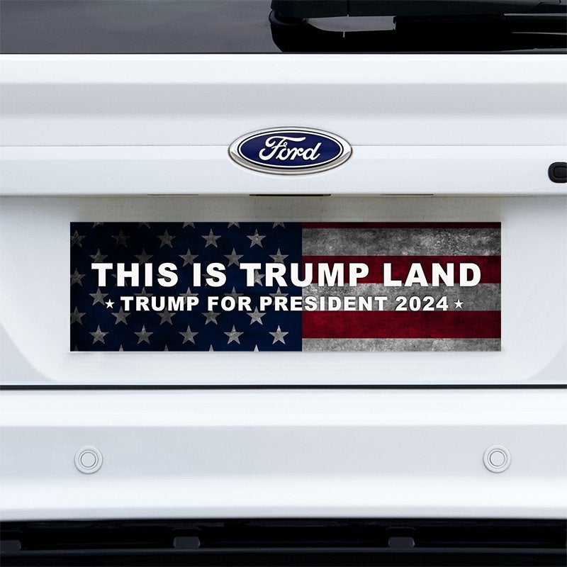 This is Trump Land Bumper Sticker on a white truck
