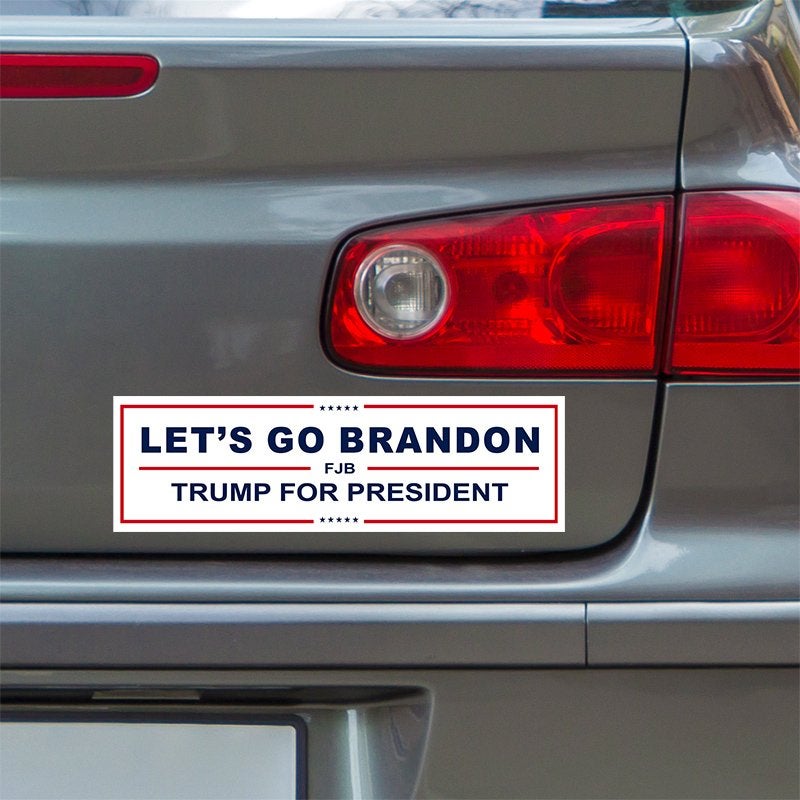 Let's Go Brandon Bumper Sticker below a gray car's tail light