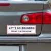 Let's Go Brandon Bumper Sticker below a gray car's tail light